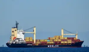 Cargo ship transporting goods for export, representing the SABER Certificate process for Saudi Arabia.